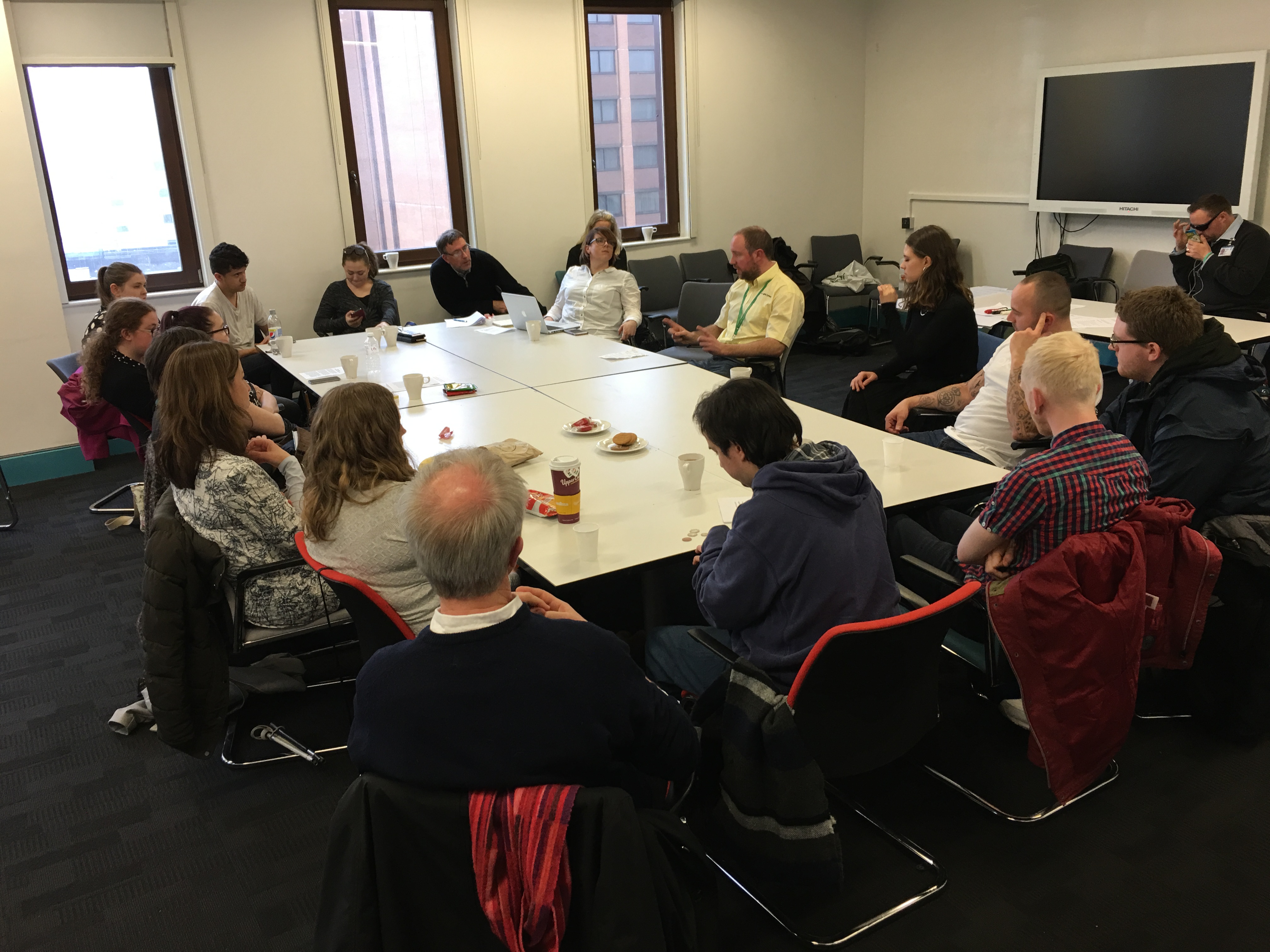 Group of young adults sat discussing the rehabilitation 